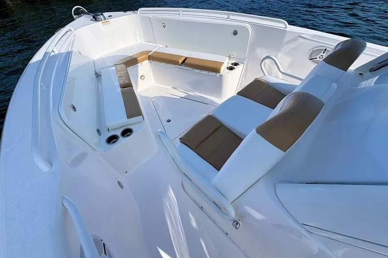 Slide: The Image of 2012 Everglades 295 Center Console boat interior with cushioned seating and cup holders. - 15