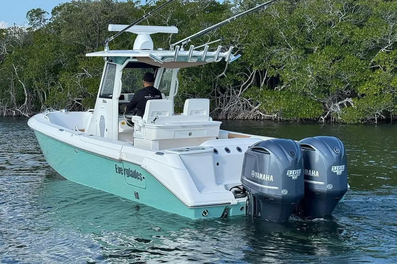 Slide: The Image of 2012 Everglades 295 Center Console boat with dual Yamaha engines on calm water. - 4