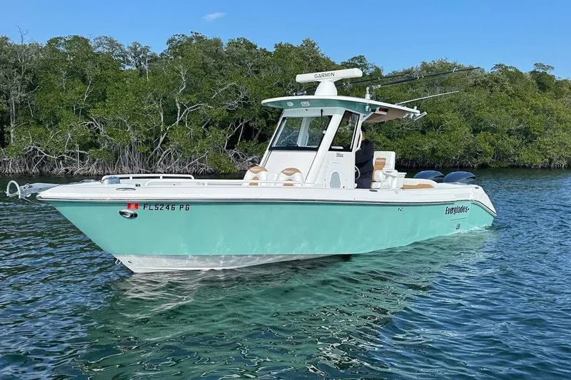 Slide: The Image of 2012 Everglades 295 Center Console boat on water, surrounded by lush greenery. - 6