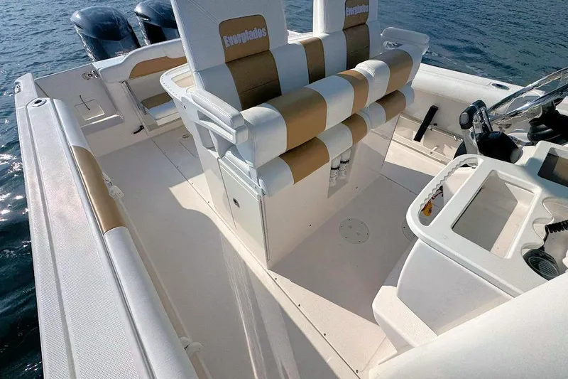 Slide: The Image of 2012 Everglades 295 Center Console boat interior with dual engines on water. - 9