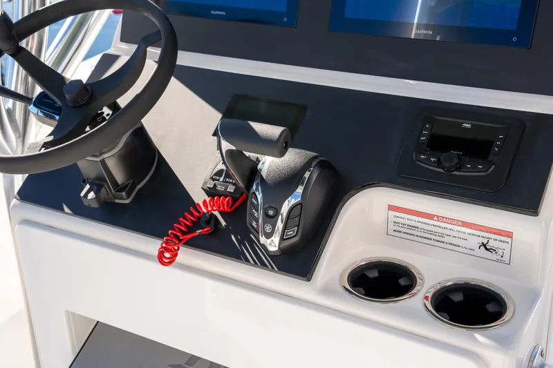 Slide: The Image of 2026 Bay Rider 269 Bay boat dashboard with steering wheel and control panel. - 12