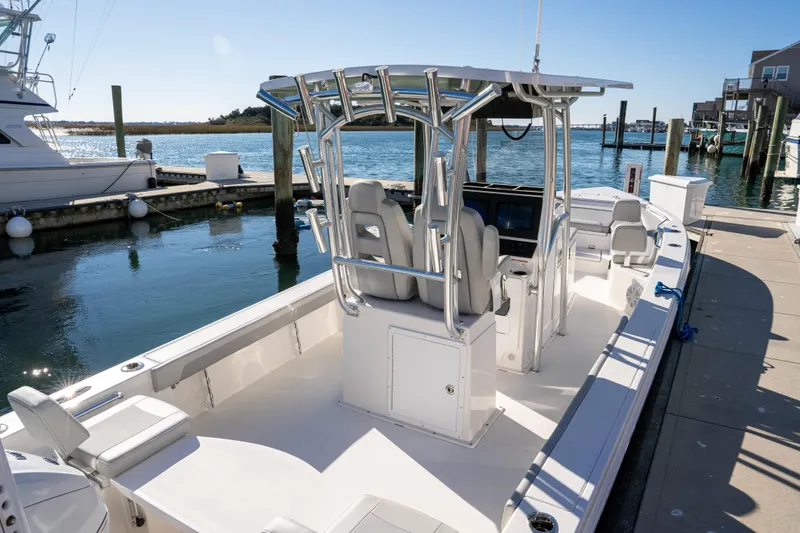 Slide: The Image of 2026 Bay Rider 269 Bay boat docked, featuring sleek design and modern amenities. - 14