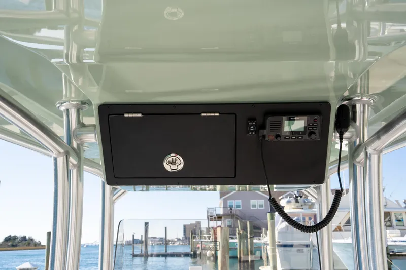 Slide: The Image of 2026 Bay Rider 269 Bay boat console with radio and storage compartment. - 16