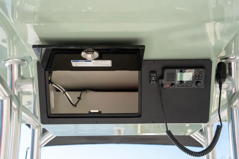 Slide: The Image of 2026 Bay Rider 269 Bay boat console with storage and Garmin marine radio. - 17