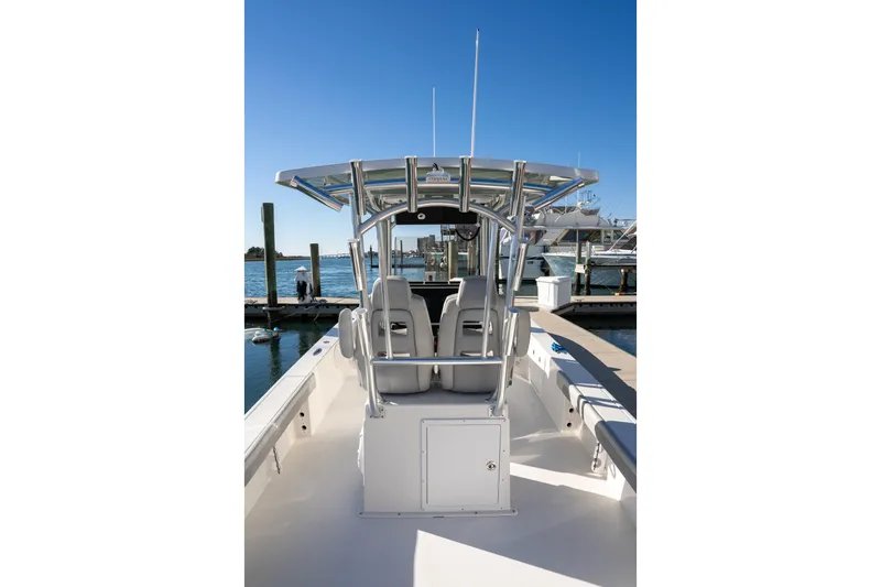 Slide: The Image of 2026 Bay Rider 269 Bay boat docked, showcasing sleek design and spacious seating. - 19