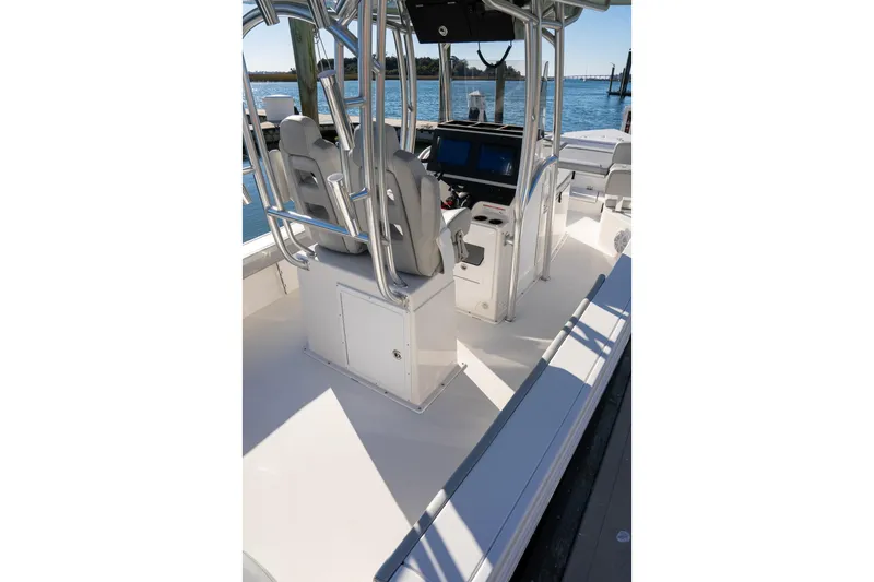 Slide: The Image of 2026 Bay Rider 269 Bay boat interior with helm, seating, and water view. - 28