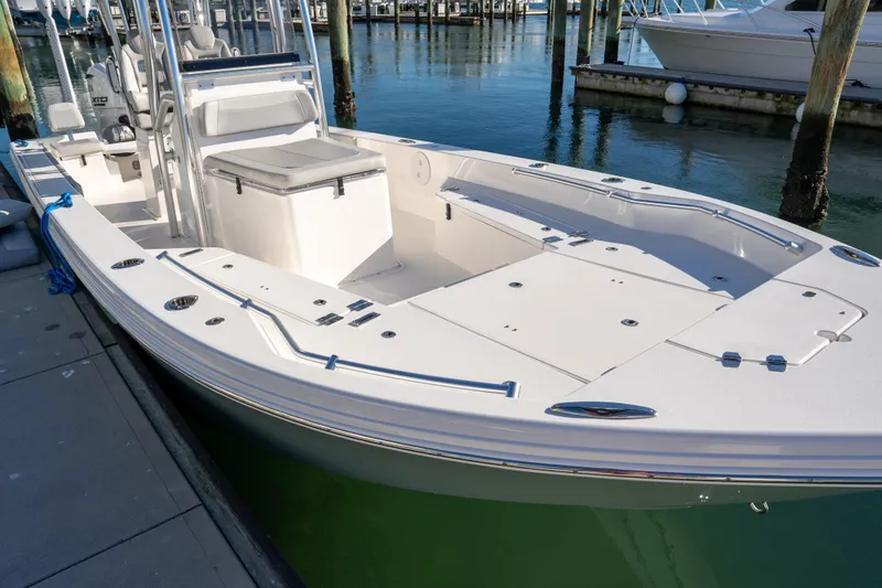 Slide: The Image of 2026 Bay Rider 269 Bay boat docked in a marina, showcasing sleek design and spacious deck. - 29