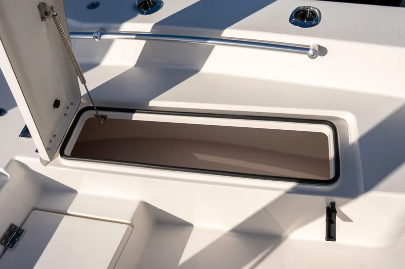 Slide: The Image of Open storage compartment on 2026 Bay Rider 269 Bay boat deck. - 31