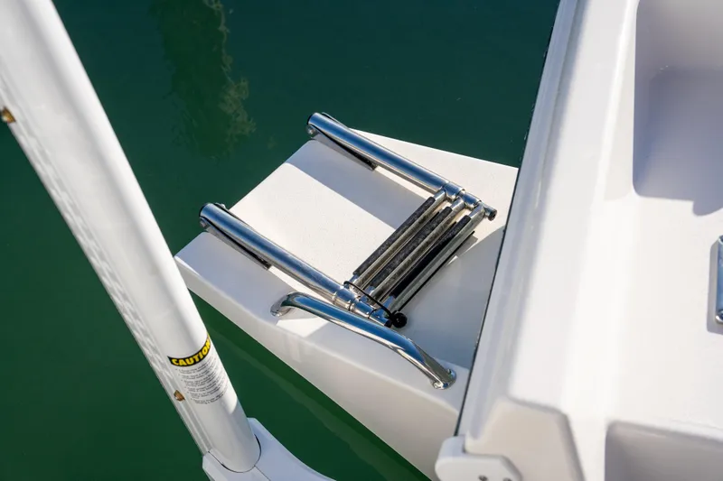 Slide: The Image of Stainless steel ladder on 2026 Bay Rider 269 Bay boat, docked in calm water. - 46