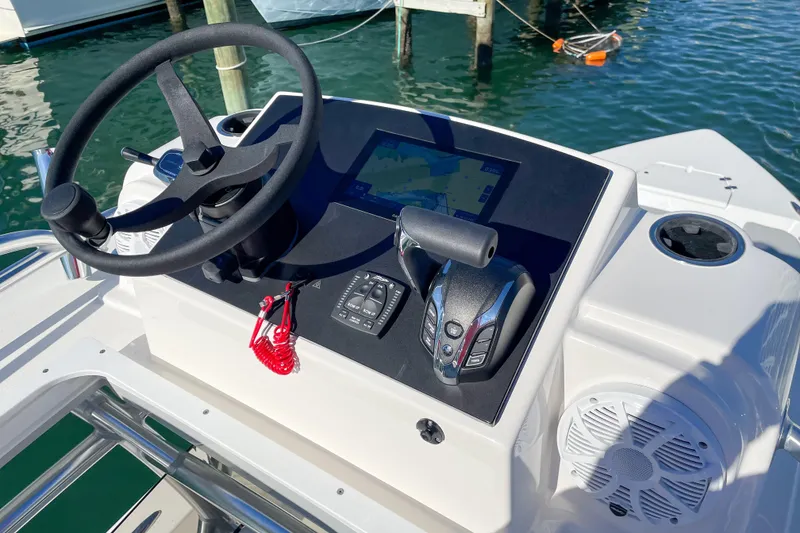 Slide: The Image of 2026 Bay Rider 269 Bay boat console with steering wheel and navigation system. - 49