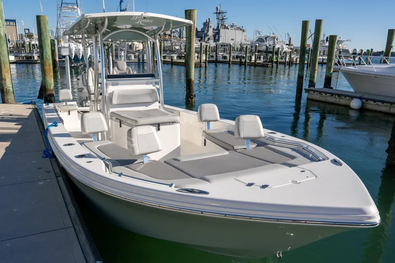Slide: The Image of 2026 Bay Rider 269 Bay boat docked at marina, featuring sleek design and spacious seating. - 5