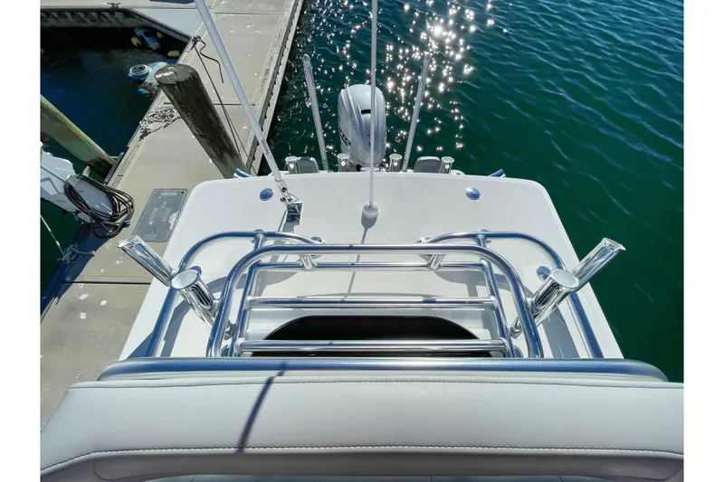 Slide: The Image of Bay Rider 269 Bay 2026 boat docked, featuring sleek metal railings and sparkling water. - 55
