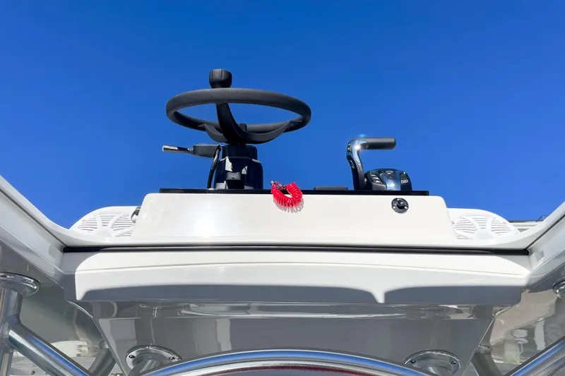 Slide: The Image of 2026 Bay Rider 269 Bay boat helm against clear blue sky. - 56