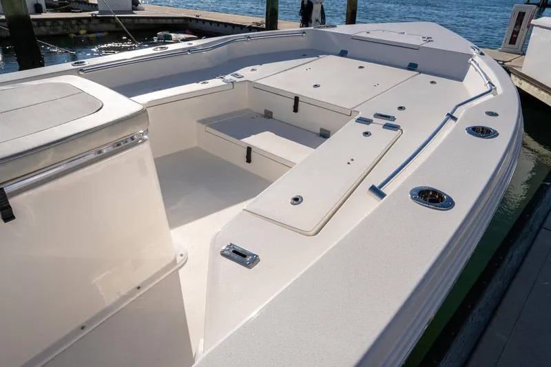 Slide: The Image of Manufacturer Provided Image: 2025 Bay Rider 269 Bay boat interior with spacious seating and storage, docked by the water. - 8