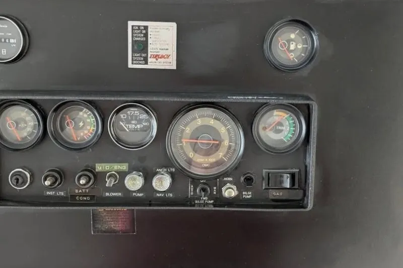 Slide: The Image of 1986 Stardust Cruisers houseboat dashboard with gauges and controls. - 17
