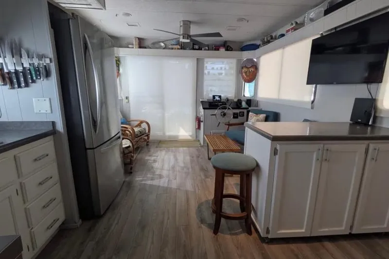 Slide: The Image of 1986 Stardust Cruisers houseboat interior with modern kitchen and living area. - 4