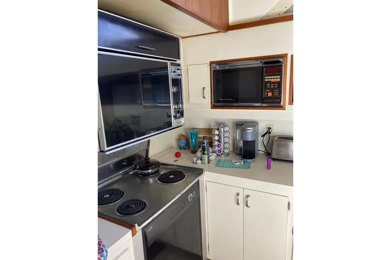Slide: The Image of Galley kitchen in 1985 Bertram 58 Flybridge Motor Yacht with stove, microwave, and appliances. - 10