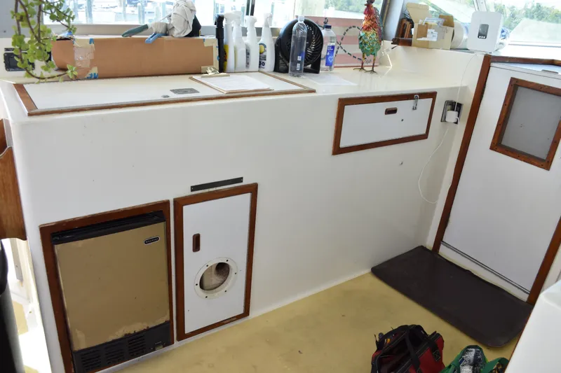 Slide: The Image of Interior of 1985 Bertram 58 Flybridge Motor Yacht with kitchenette and storage. - 19