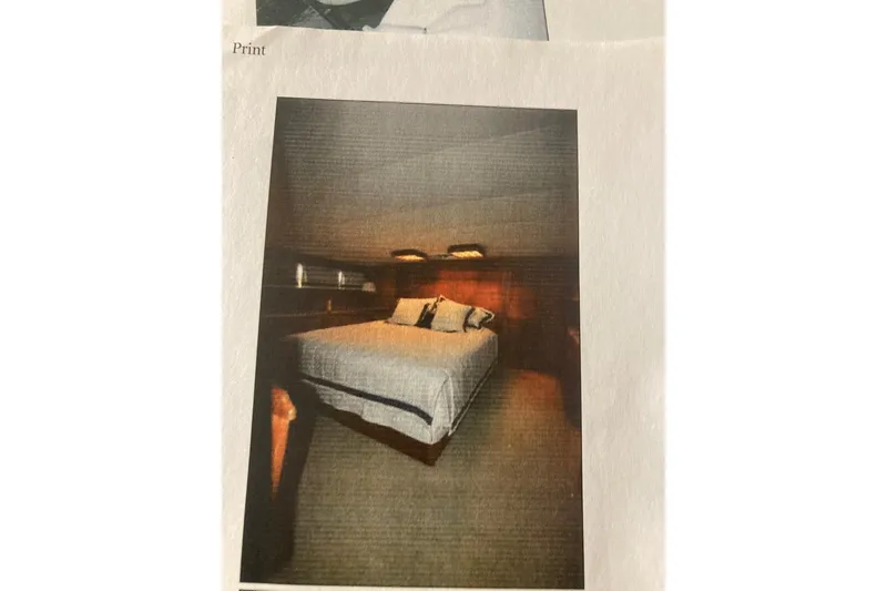 Slide: The Image of Luxurious bedroom interior of 1985 Bertram 58 Flybridge Motor Yacht, featuring cozy bedding and warm lighting. - 23