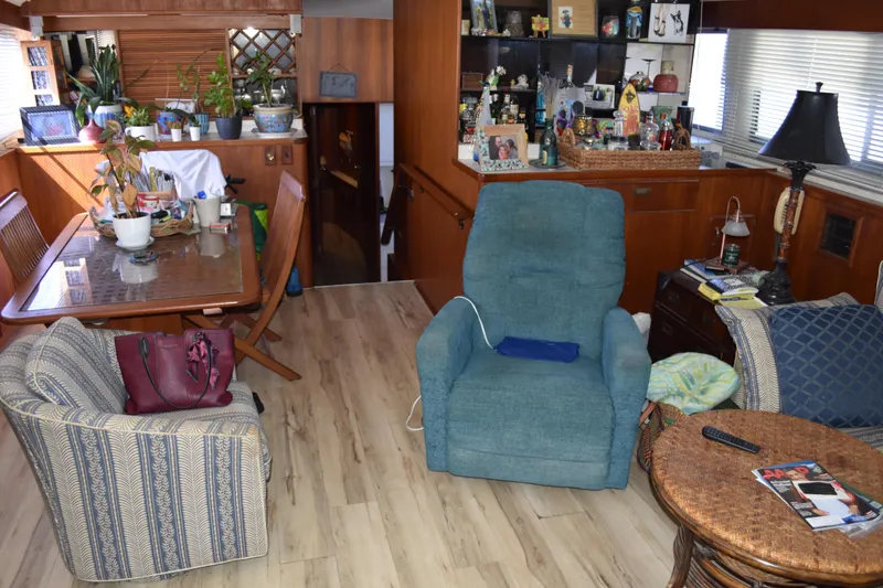 Slide: The Image of Interior of a 1985 Bertram 58 Flybridge Motor Yacht with cozy seating and decor. - 27