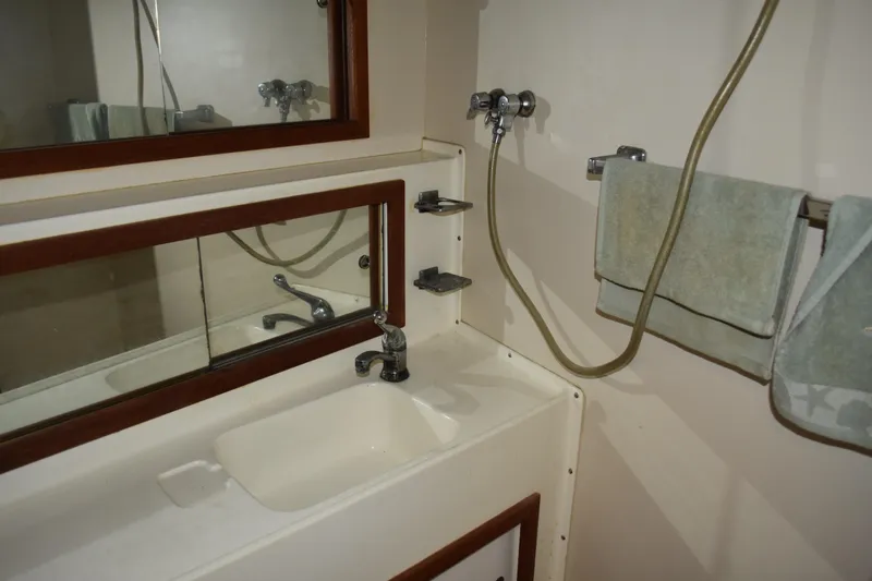 Slide: The Image of Bathroom interior of 1985 Bertram 58 Flybridge Motor Yacht with sink and mirror. - 33
