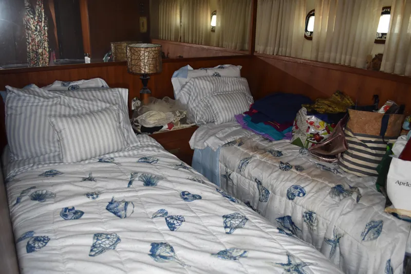 Slide: The Image of Interior of 1985 Bertram 58 Flybridge Motor Yacht with twin beds and nautical decor. - 34