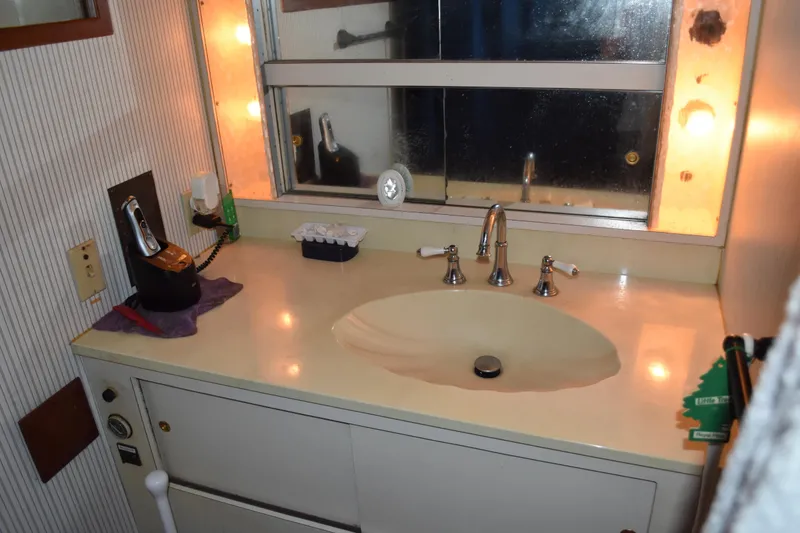 Slide: The Image of Bathroom vanity in 1985 Bertram 58 Flybridge Motor Yacht with mirror and lighting. - 39
