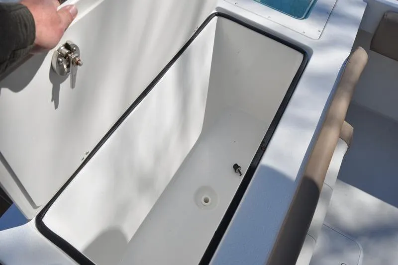 Slide: The Image of Open storage compartment on a 2018 Parker 2300 Center Console boat. - 11
