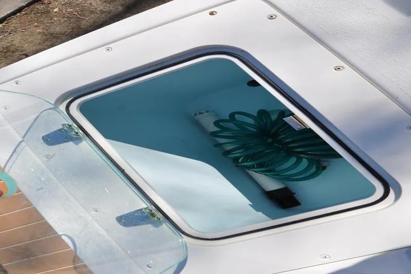 Slide: The Image of Open storage compartment on 2018 Parker 2300 Center Console boat. - 12