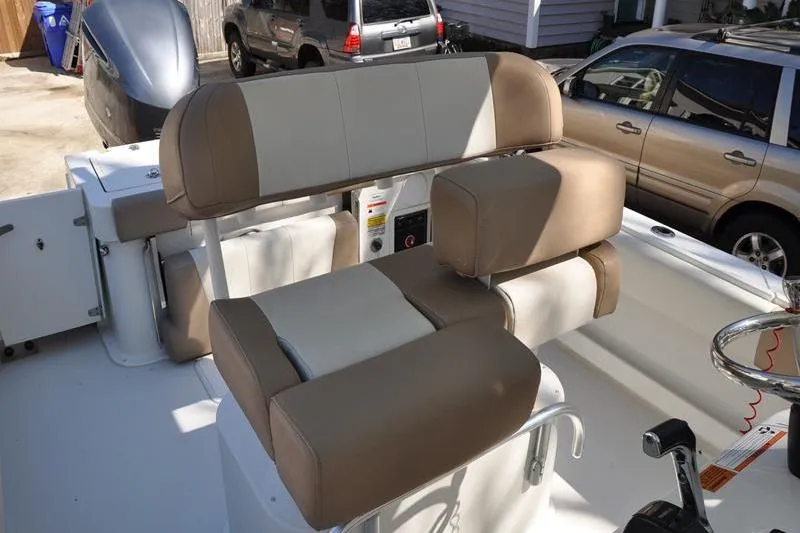 Slide: The Image of 2018 Parker 2300 Center Console boat interior with beige seating and steering wheel. - 17