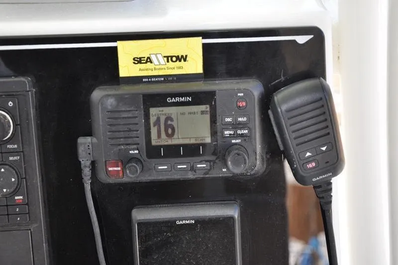 Slide: The Image of Garmin marine radio on 2018 Parker 2300 Center Console boat dashboard with Sea Tow card. - 19