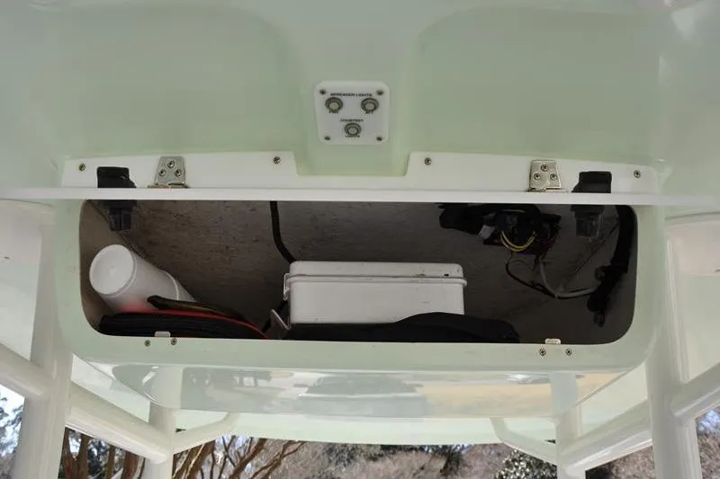 Slide: The Image of 2018 Parker 2300 Center Console storage compartment with equipment and wiring. - 25