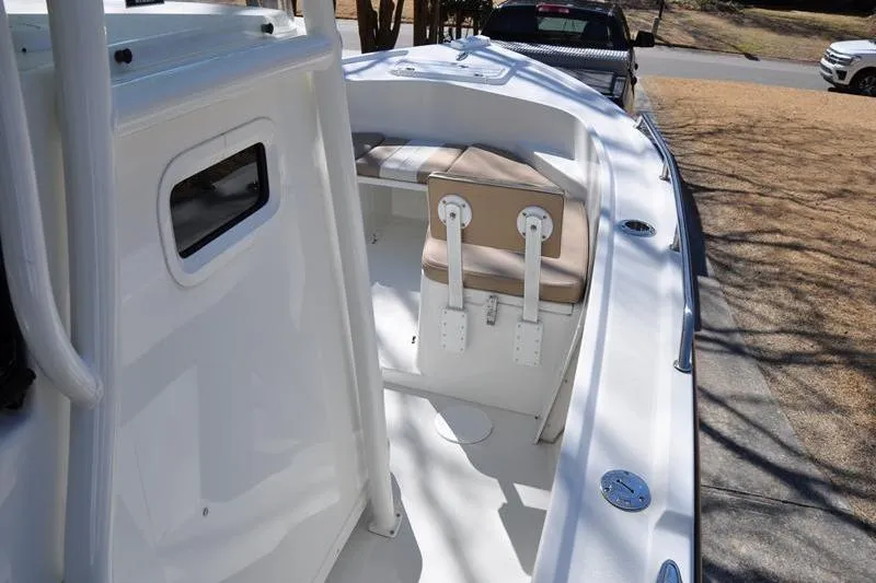 Slide: The Image of 2018 Parker 2300 Center Console boat with seating and storage, parked outdoors. - 26