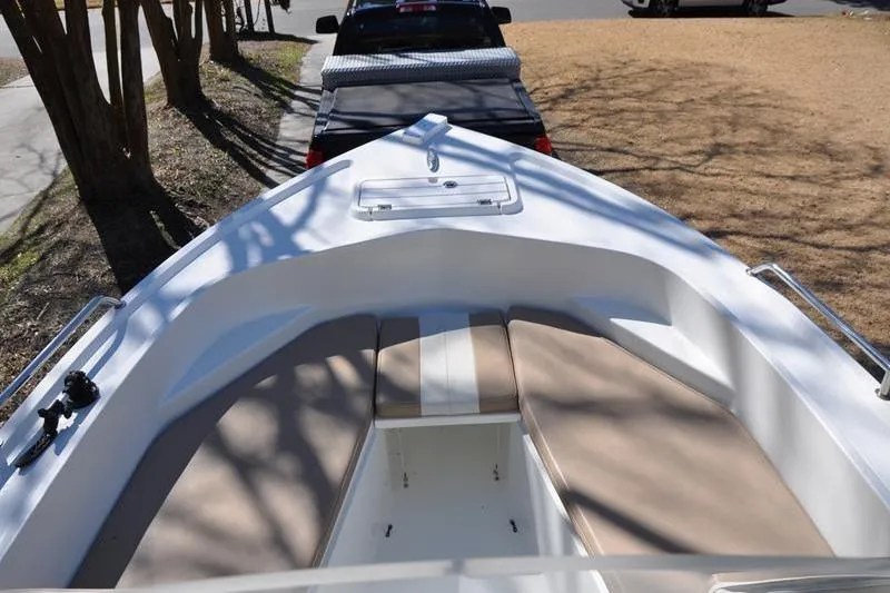 Slide: The Image of 2018 Parker 2300 Center Console boat with cushioned seating, parked on a trailer. - 31