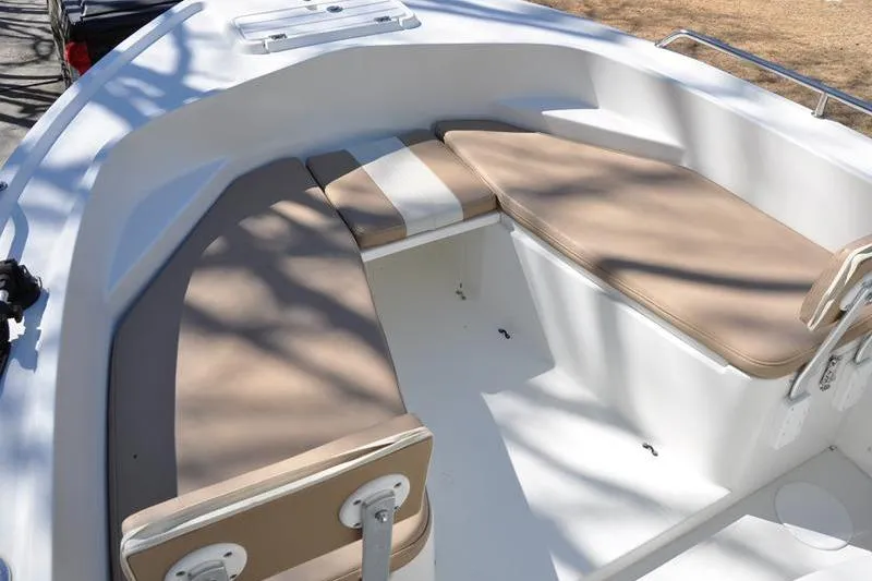 Slide: The Image of 2018 Parker 2300 Center Console boat with beige cushioned seating area. - 32