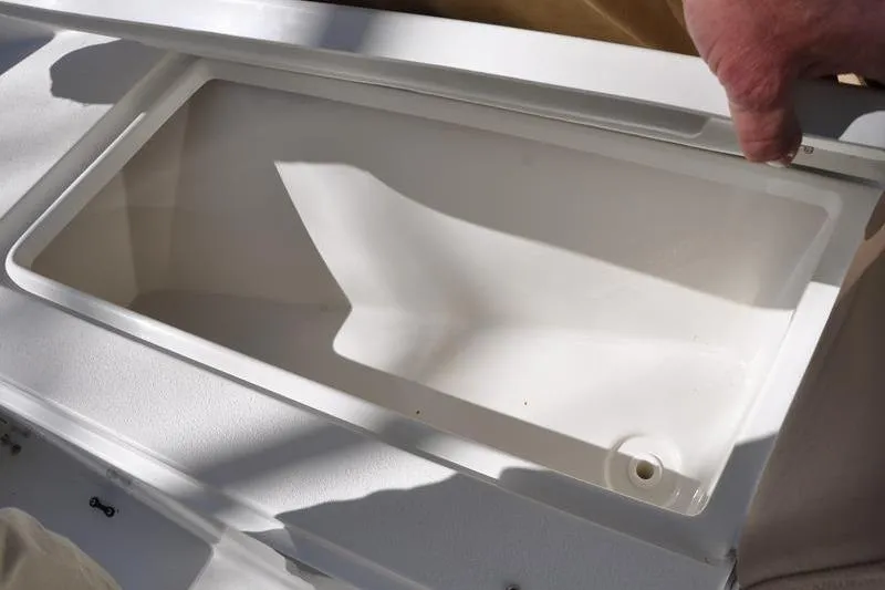 Slide: The Image of Open storage compartment on a 2018 Parker 2300 Center Console boat. - 34