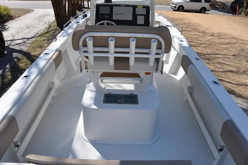 Slide: The Image of 2018 Parker 2300 Center Console boat with seating and rod holders, parked outdoors. - 6