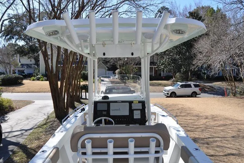 Slide: The Image of 2018 Parker 2300 Center Console boat with T-top and electronics, parked in a residential driveway. - 7