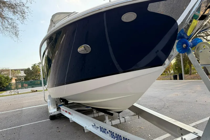 Slide: The Image of 2019 Regal 29 OBX boat on trailer in parking lot, side view. - 11