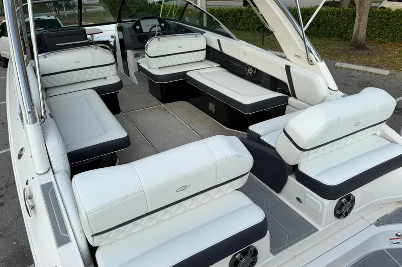 Slide: The Image of 2019 Regal 29 OBX boat interior with luxurious white seating and modern dashboard. - 12