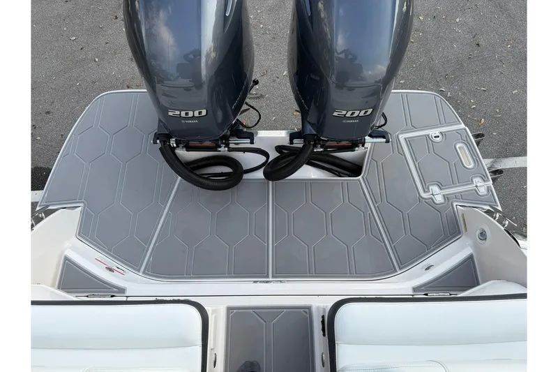 Slide: The Image of 2019 Regal 29 OBX boat with twin Yamaha 200 engines on gray deck. - 13