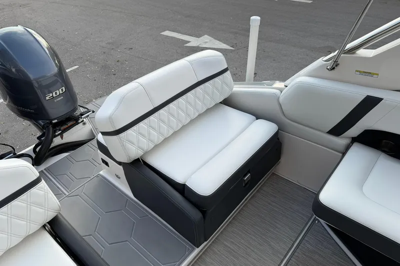 Slide: The Image of 2019 Regal 29 OBX boat interior with white seating and Yamaha 200 engine. - 16