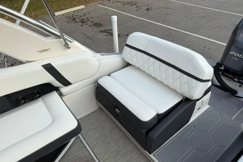Slide: The Image of 2019 Regal 29 OBX boat interior with white cushioned seating and Yamaha 200 engine. - 17
