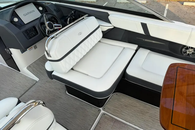 Slide: The Image of 2019 Regal 29 OBX boat interior with white seating and Garmin navigation system. - 20