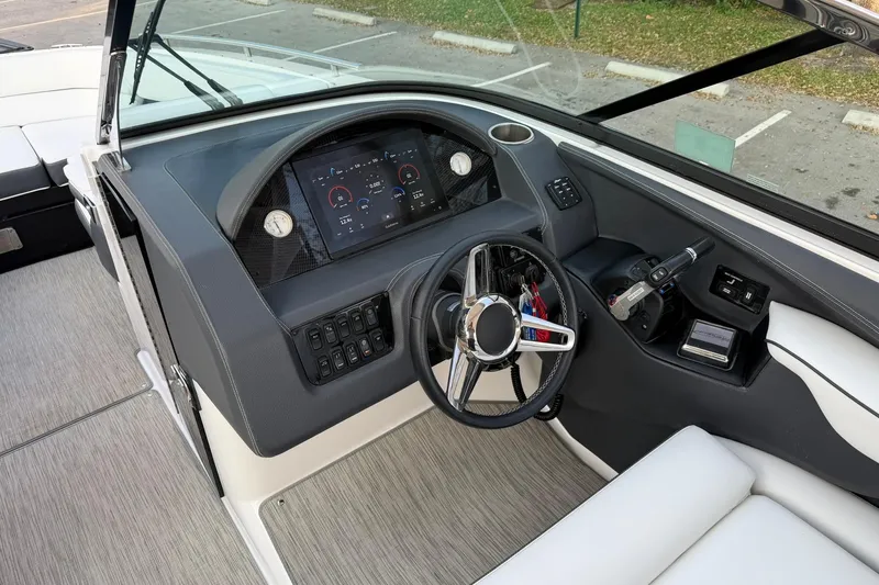 Slide: The Image of 2019 Regal 29 OBX boat dashboard with modern controls and steering wheel. - 24