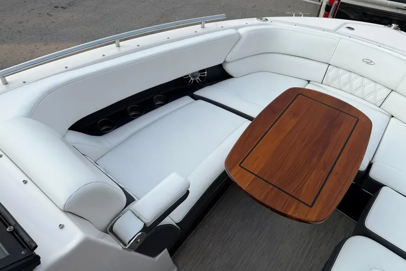 Slide: The Image of Luxurious seating area on 2019 Regal 29 OBX boat with elegant wooden table. - 29