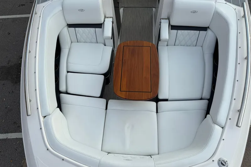Slide: The Image of Luxurious 2019 Regal 29 OBX boat interior with white seating and wooden table. - 30