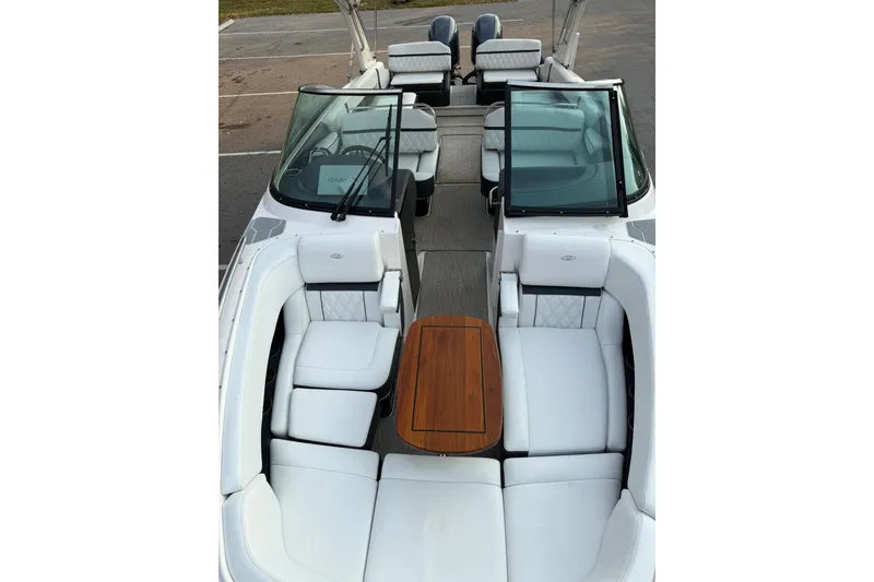 Slide: The Image of 2019 Regal 29 OBX boat interior with white seating and wooden table. - 31
