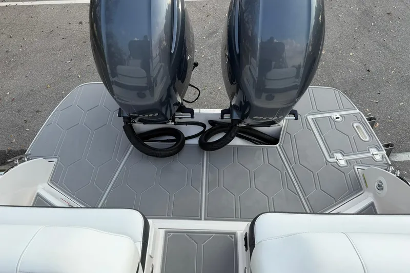 Slide: The Image of 2019 Regal 29 OBX boat with dual outboard motors on a gray deck. - 35