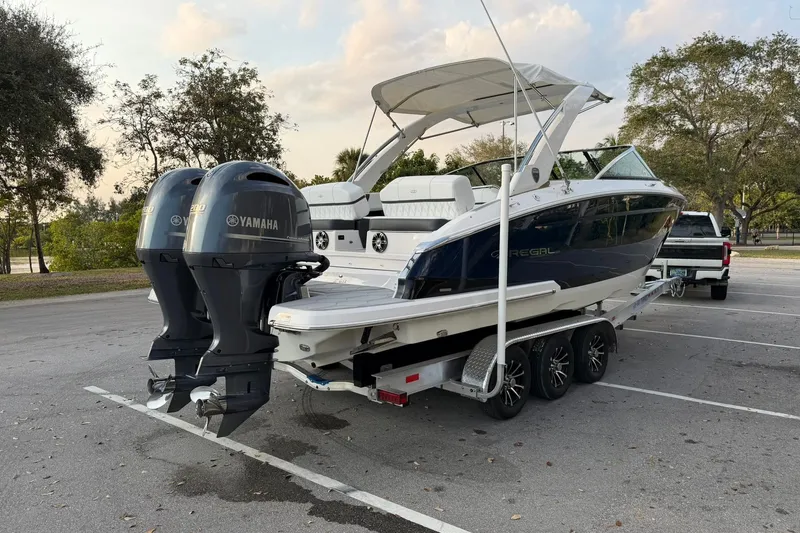 Slide: The Image of 2019 Regal 29 OBX boat with twin Yamaha engines on a trailer in a parking lot. - 4